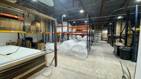Warehouse interior with pallets, shelving units, and storage equipment.